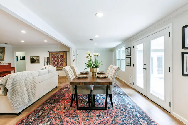 a living room with furniture a large window and a flat screen tv