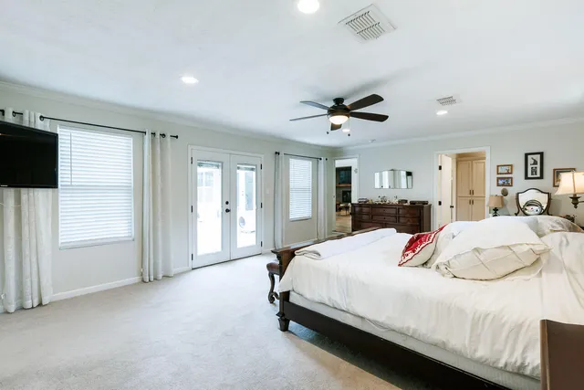 a bedroom with a bed and a chandelier