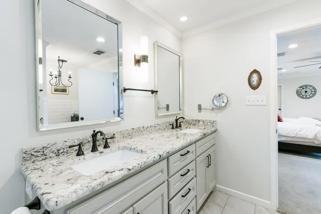 a bathroom with a granite countertop sink and a mirror