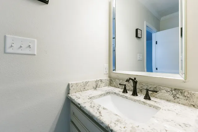 a view of a patio with table and chairs and potted plants with large tree