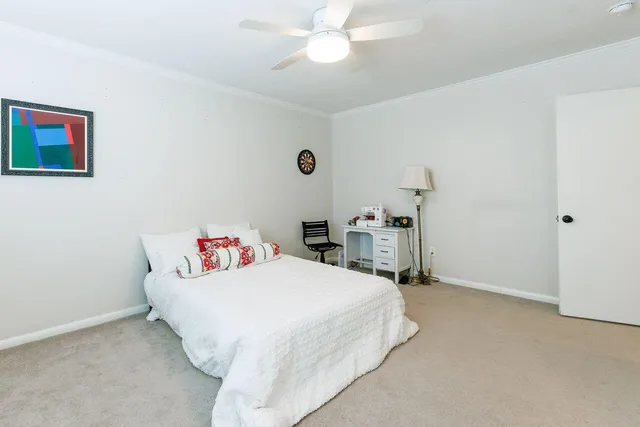 a view of a patio with a dining table and chairs with wooden fence