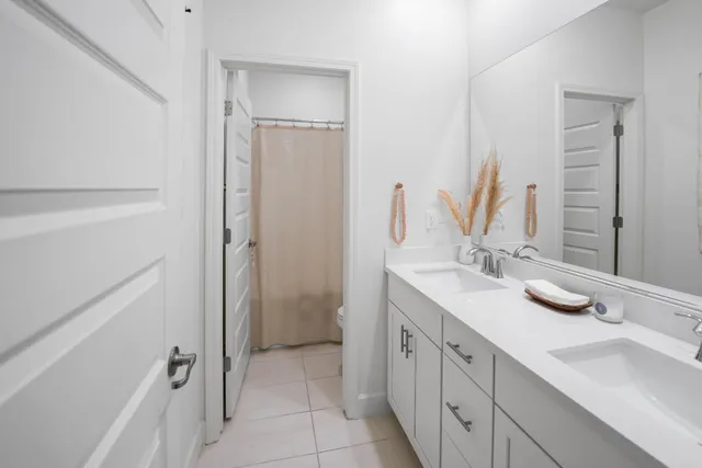 a bathroom with a double vanity sink mirror and