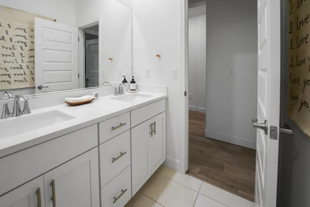 a bathroom with a double vanity sink and a mirror