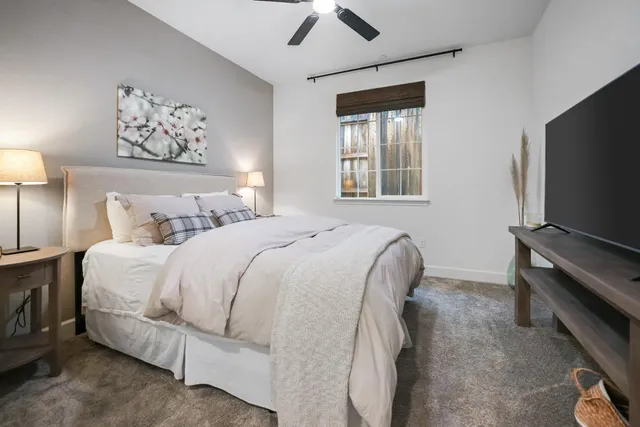 a bedroom with a bed and a flat screen tv