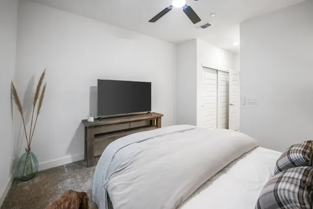 a bedroom with a bed and a flat screen tv