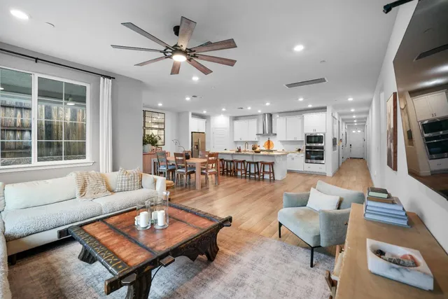 a living room with furniture and kitchen view