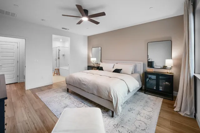 a bedroom with a bed and a chandelier