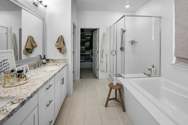 a bathroom with a tub sink and mirror