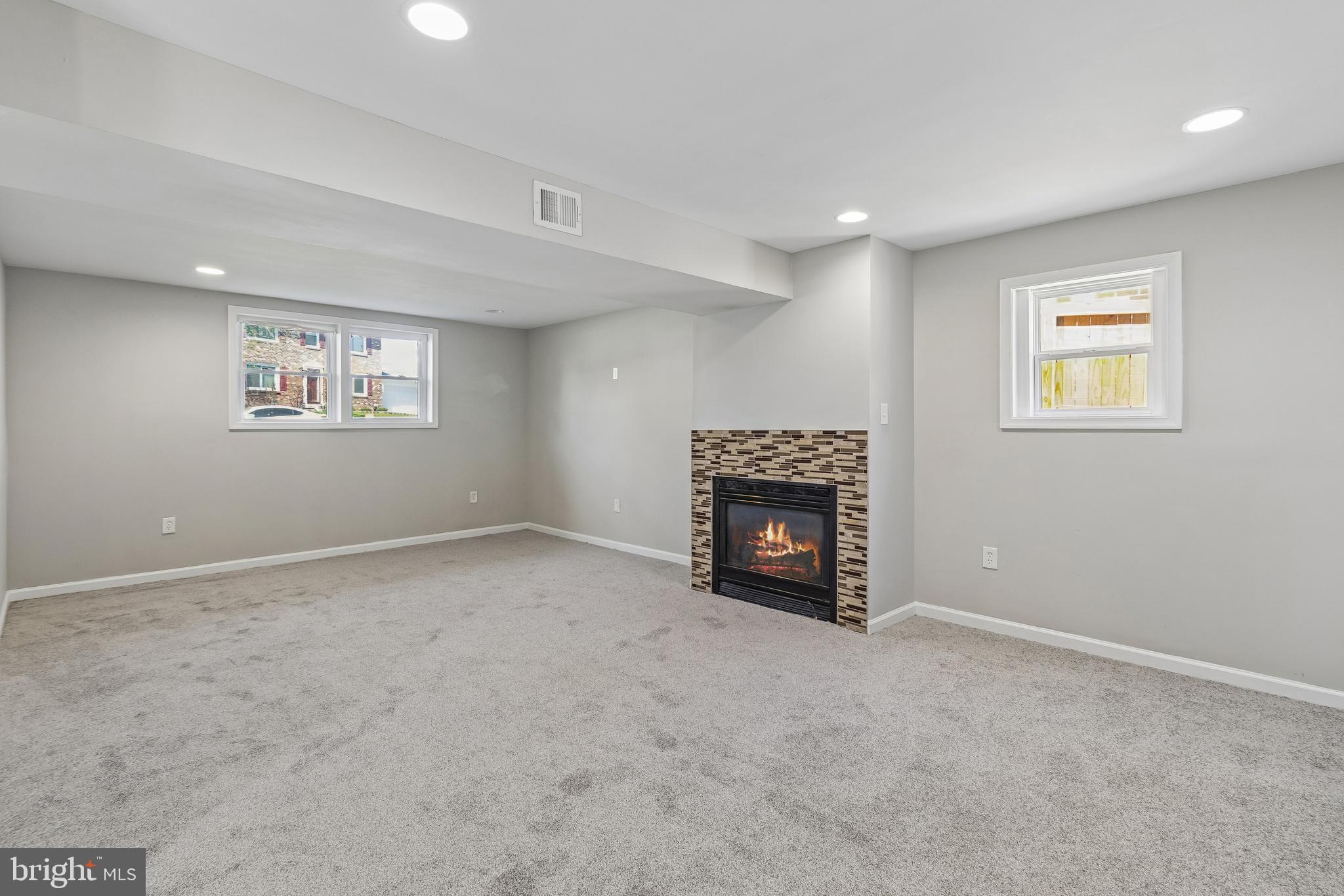 5903 Sylvia Court Clinton, MD 20735 - Photo 12 of 21 an empty room with a fireplace and a window