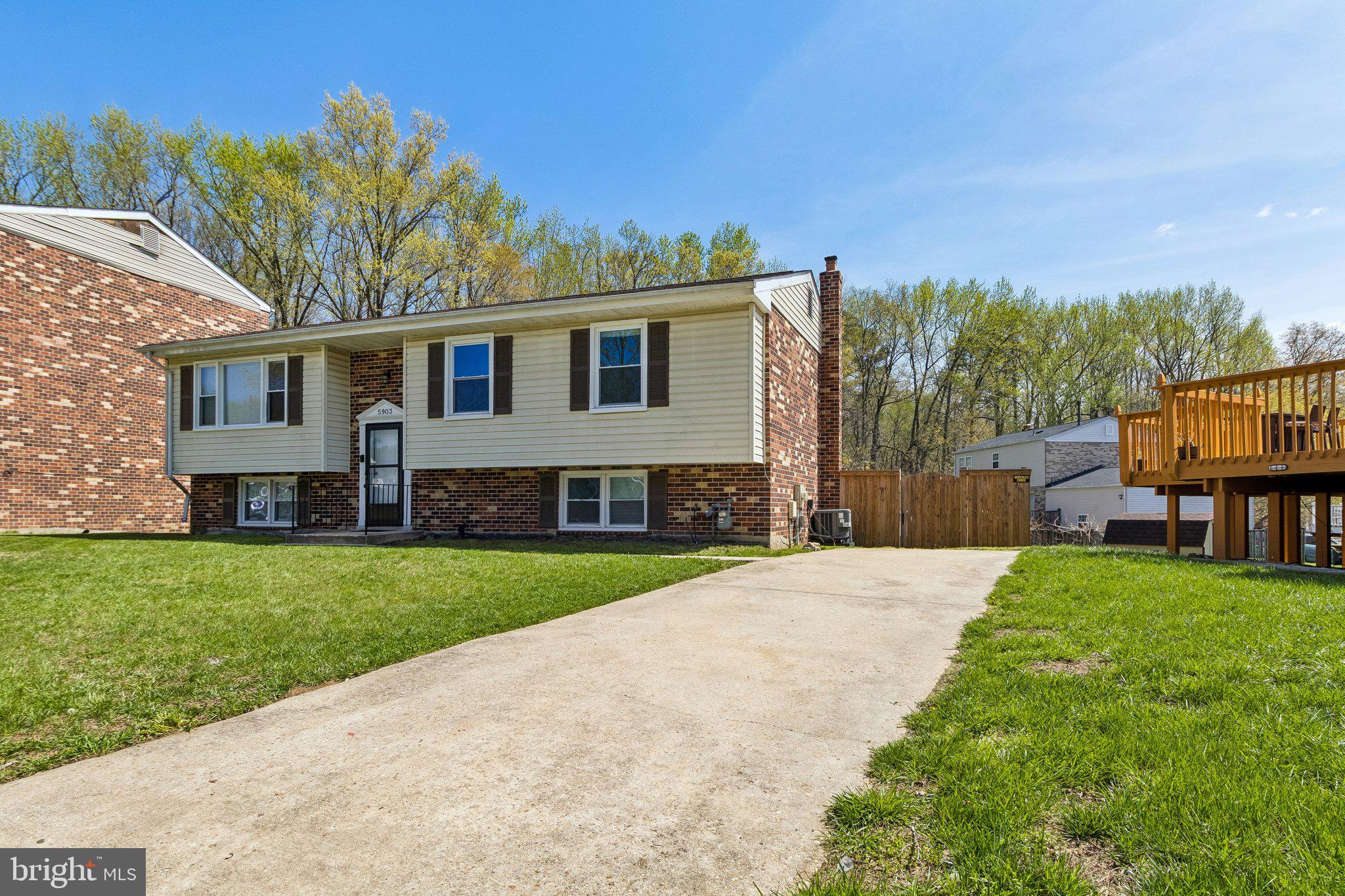 5903 Sylvia Court Clinton, MD 20735 - Photo 19 of 21 a front view of a house with a garden and yard