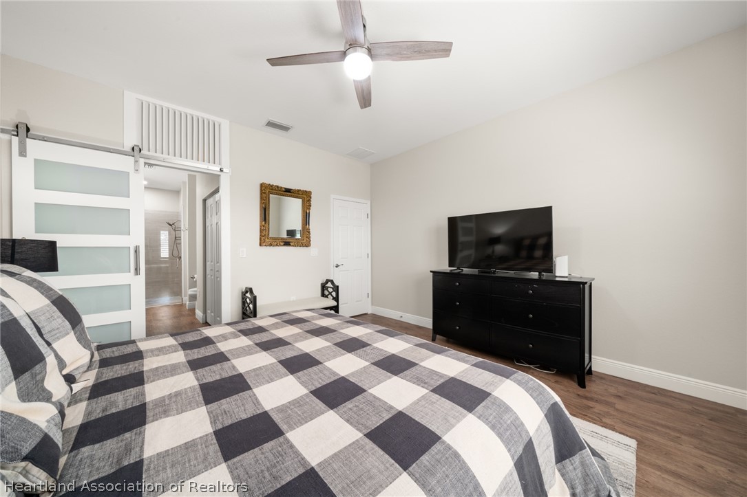 4734 Haw Branch Road, Unit 110 Sebring, FL 33875 - Photo 21 of 50 a bedroom with a bed and a television