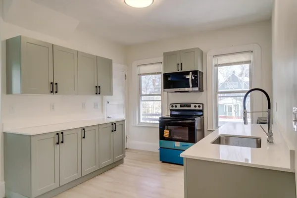 a kitchen with a sink stove and refrigerator