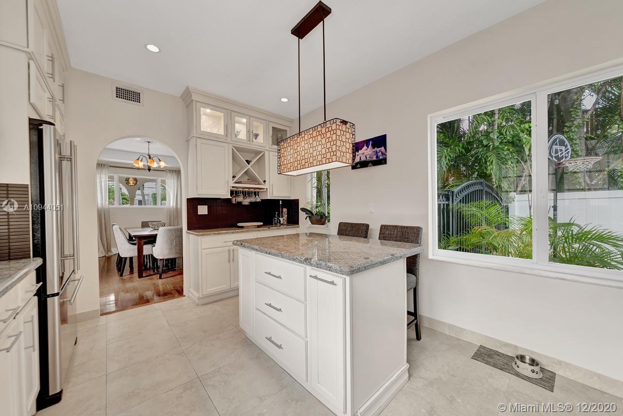 2203 North Bay Road Miami Beach, FL 33140 - Photo 11 of 36 a kitchen with a stove a refrigerator and a view of living room