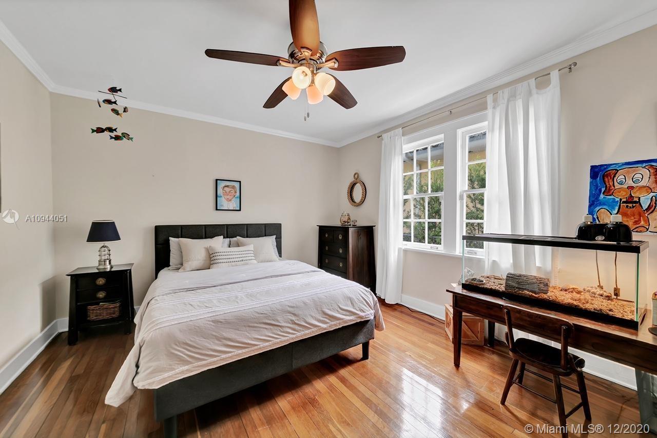 2203 North Bay Road Miami Beach, FL 33140 - Photo 13 of 36 a bedroom with a bed and a table