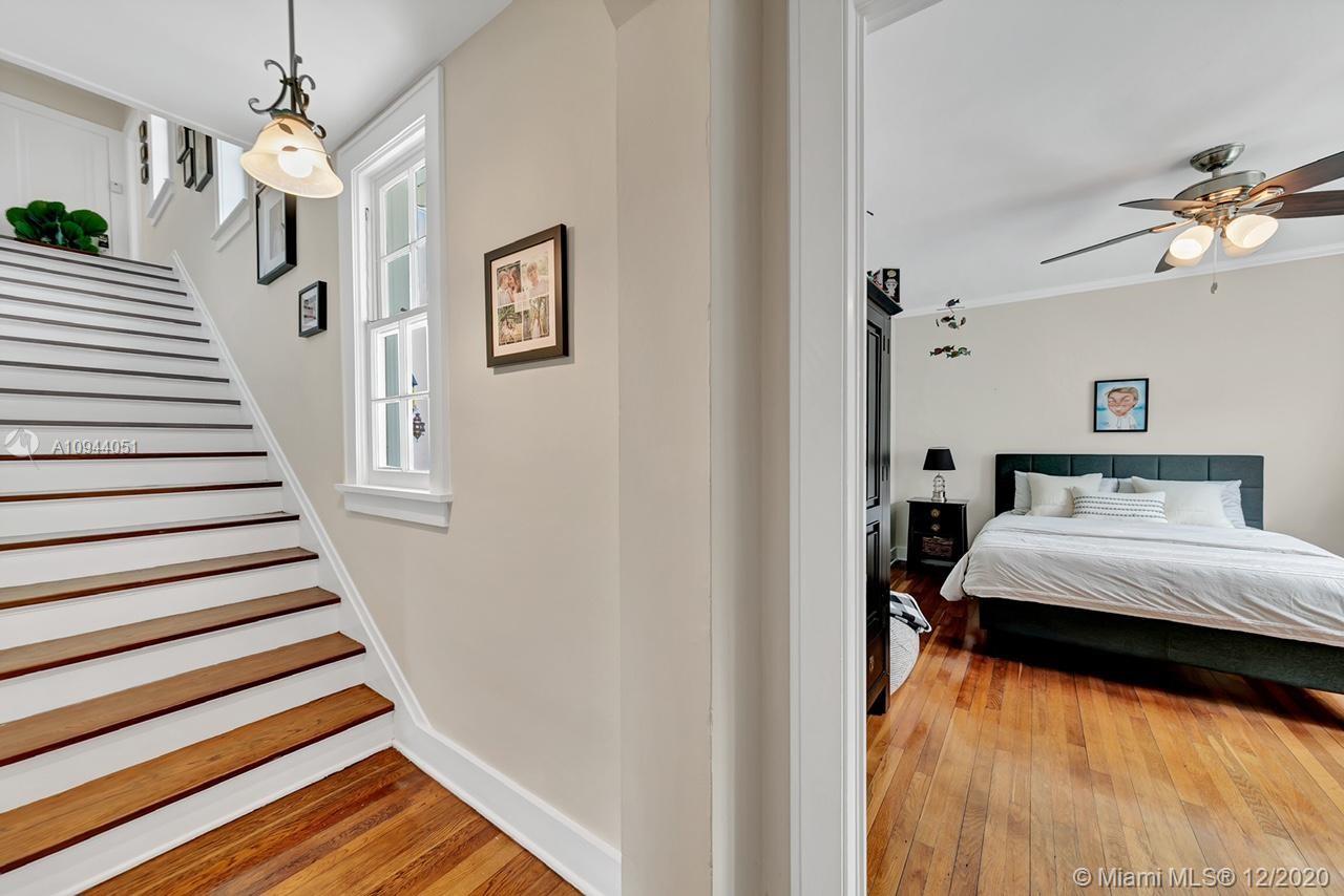 2203 North Bay Road Miami Beach, FL 33140 - Photo 15 of 36 a bedroom with a bed and a chandelier