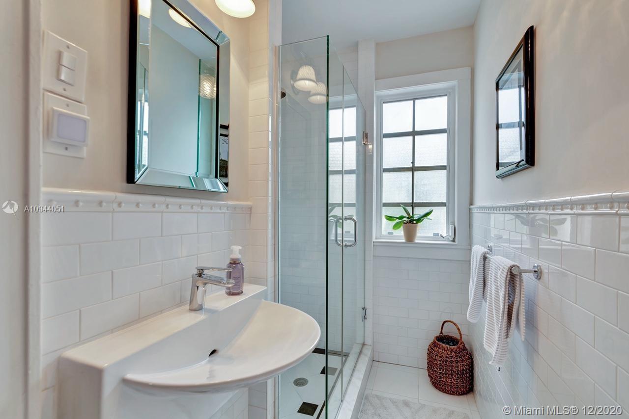 2203 North Bay Road Miami Beach, FL 33140 - Photo 16 of 36 a bathroom with a sink and a window