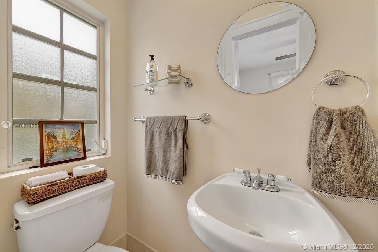 2203 North Bay Road Miami Beach, FL 33140 - Photo 23 of 36 a bathroom with a sink toilet and mirror