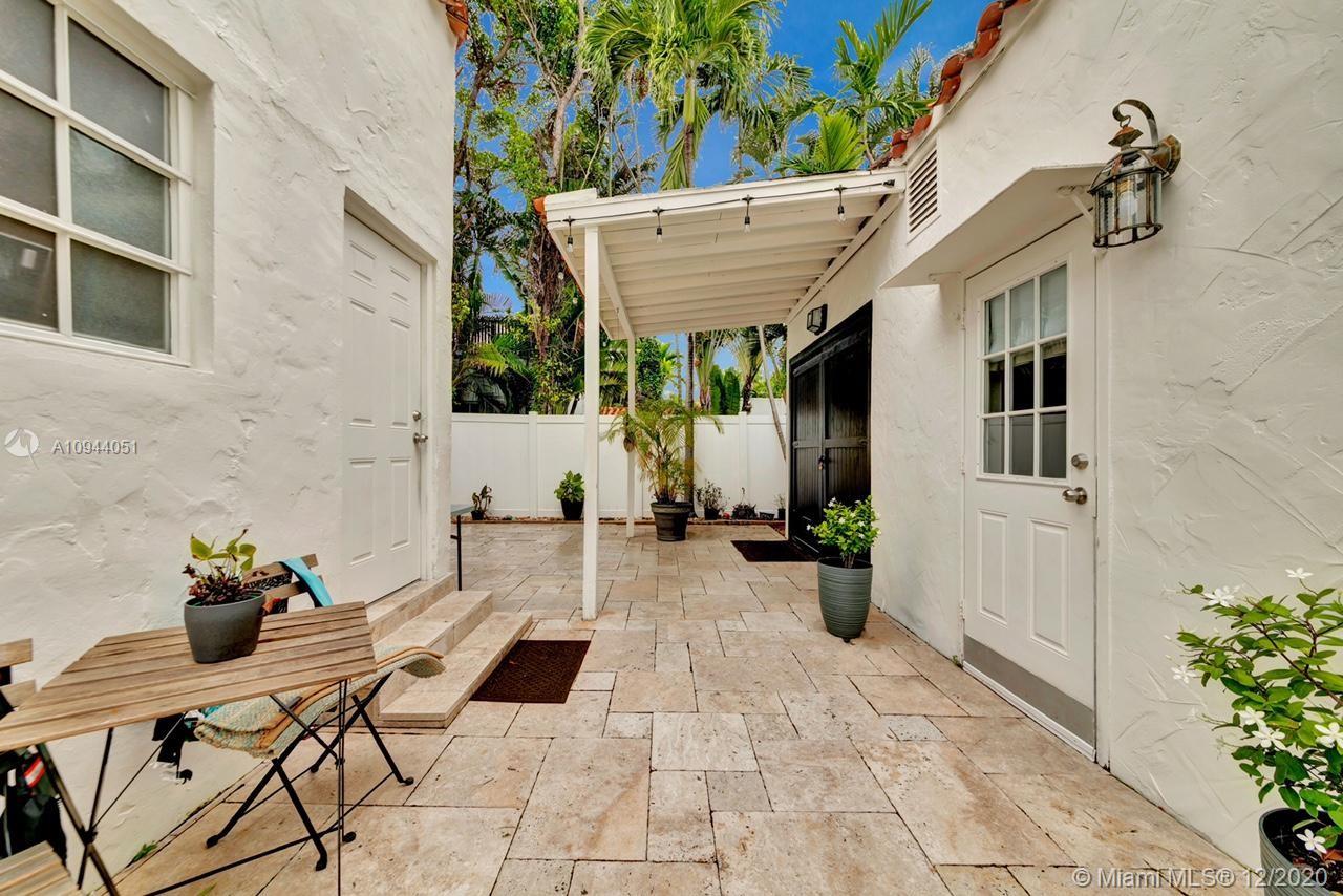 2203 North Bay Road Miami Beach, FL 33140 - Photo 25 of 36 a view of a chairs and table in the patio