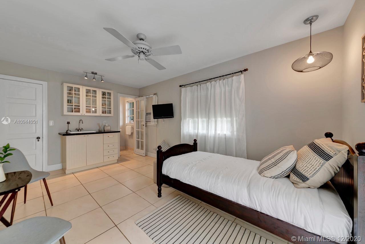 2203 North Bay Road Miami Beach, FL 33140 - Photo 26 of 36 a bedroom with a bed and a view of kitchen
