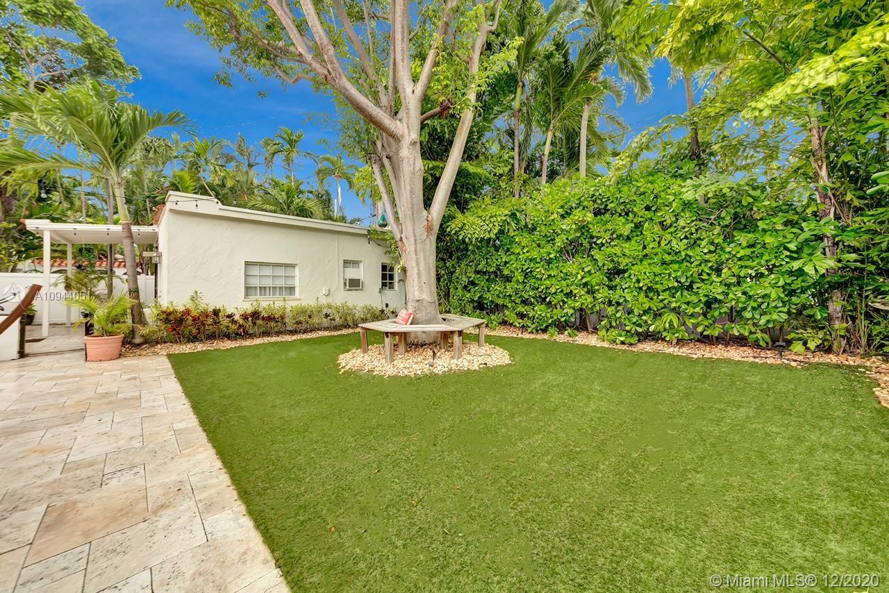 2203 North Bay Road Miami Beach, FL 33140 - Photo 32 of 36 a view of a swimming pool with lounge chair