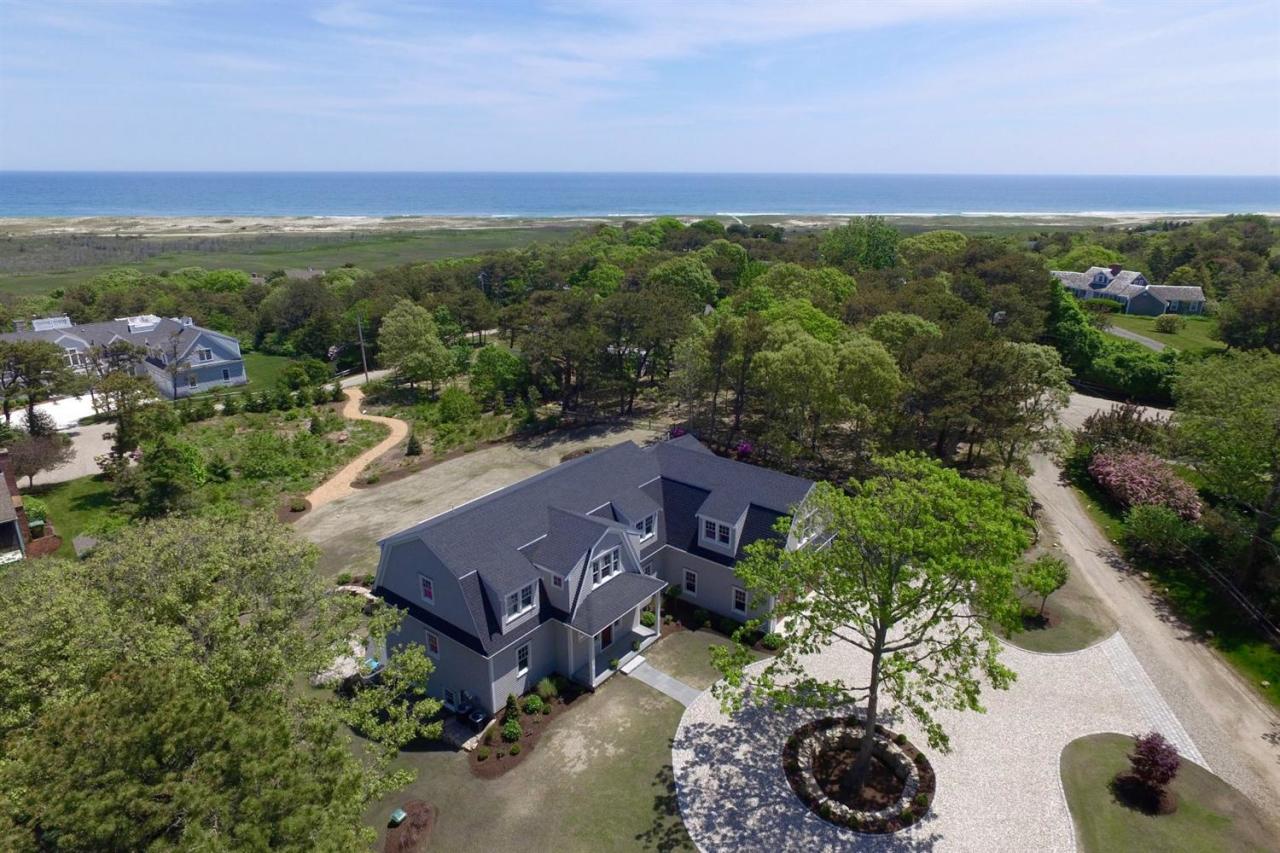38 Woods Neck Road Orleans, MA 02653 - Photo 1 of 35 aerial view of a house with a yard and lake view
