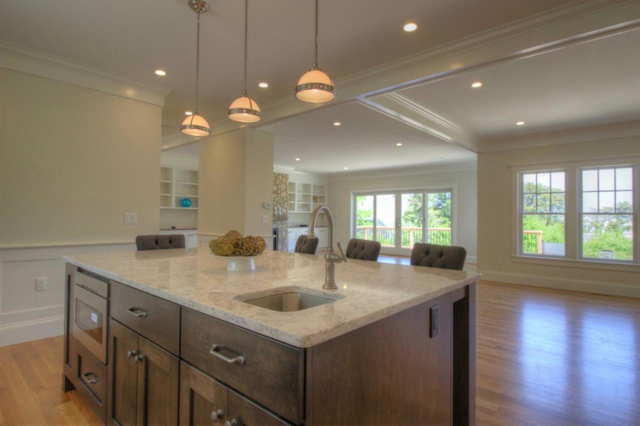 38 Woods Neck Road Orleans, MA 02653 - Photo 26 of 35 a kitchen with granite countertop a sink a stove and wooden floor
