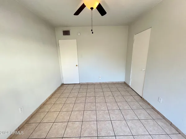 an empty room with white walls and windows