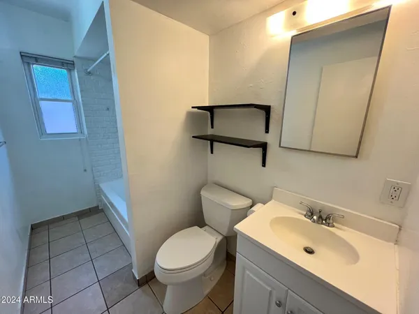 a bath tub sitting next to a white sink and vanity