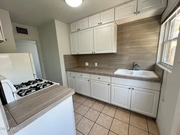 a kitchen with a sink and cabinets