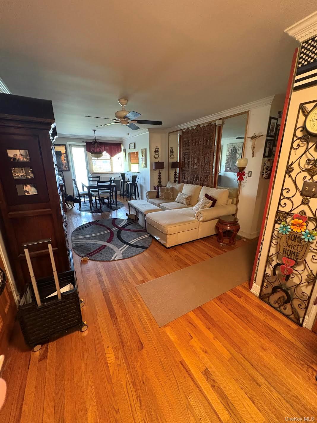 153-25 88th Street, Unit 5L Queens, NY 11414 - Photo 4 of 7 a living room with furniture and a flat screen tv