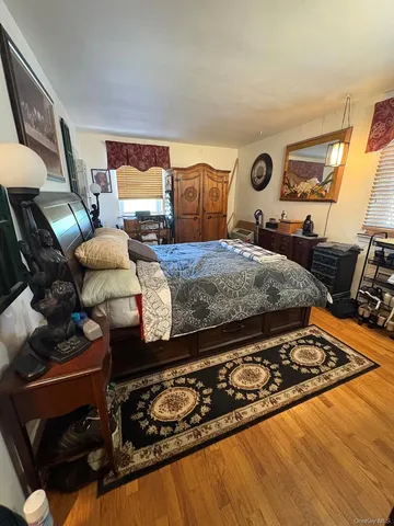 a bedroom with bed couch and window