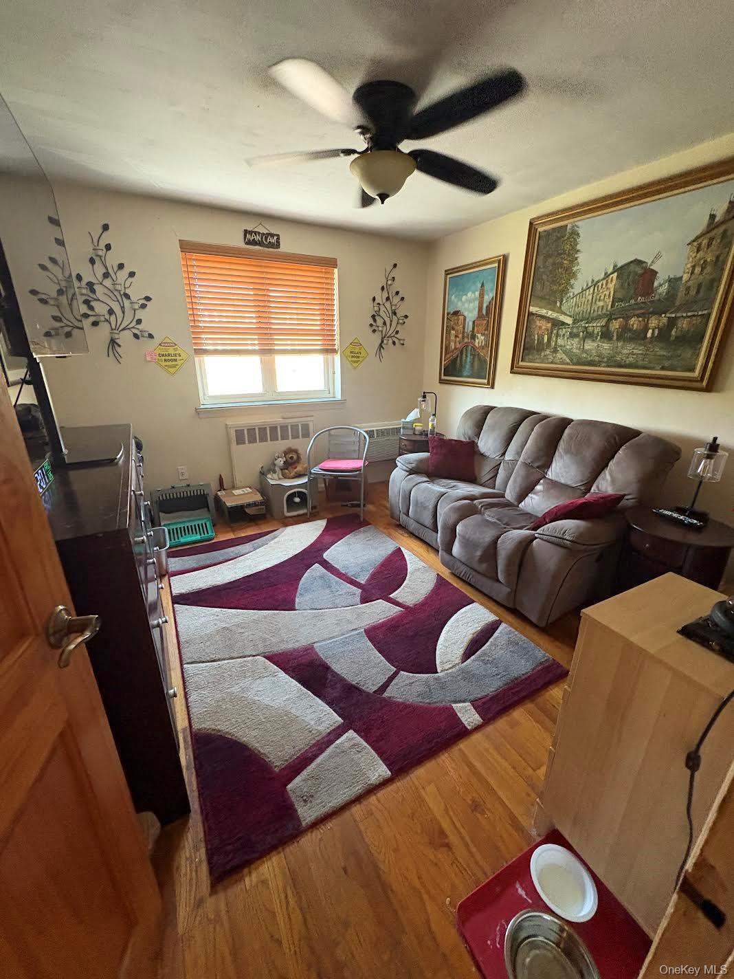 153-25 88th Street, Unit 5L Queens, NY 11414 - Photo 7 of 7 a living room with furniture and a large window