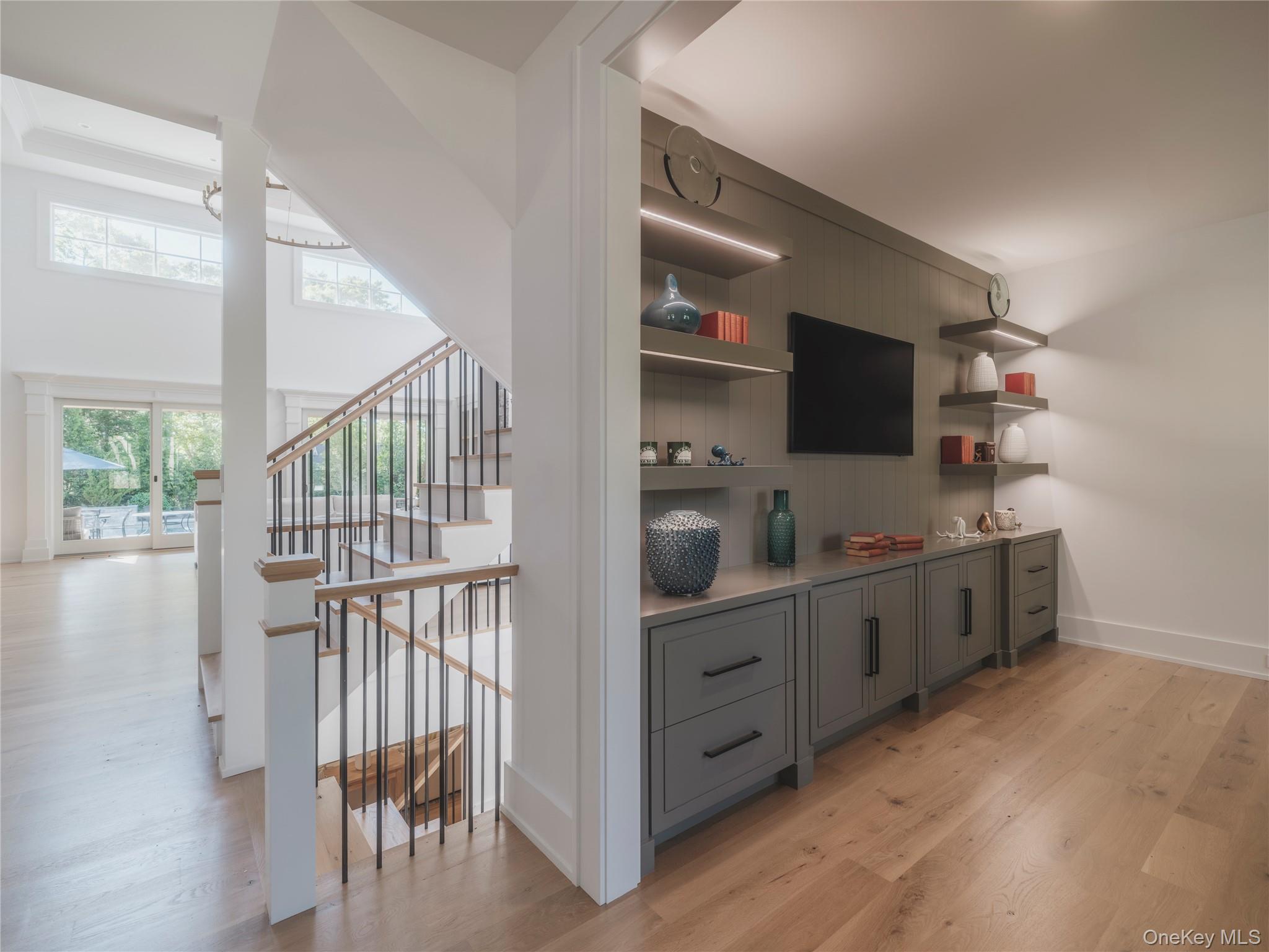 465 Ripple Water Lane Southold, NY 11971 - Photo 16 of 46 Bar featuring gray cabinetry, light wood-style flooring, open shelves, and light countertops