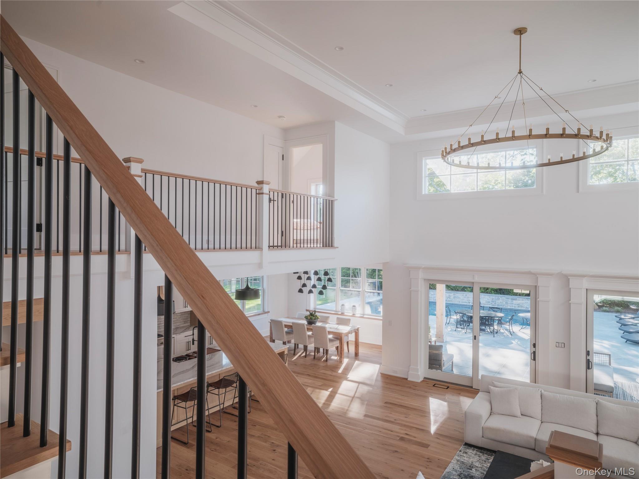 465 Ripple Water Lane Southold, NY 11971 - Photo 19 of 47 Stairs featuring wood finished floors and crown molding