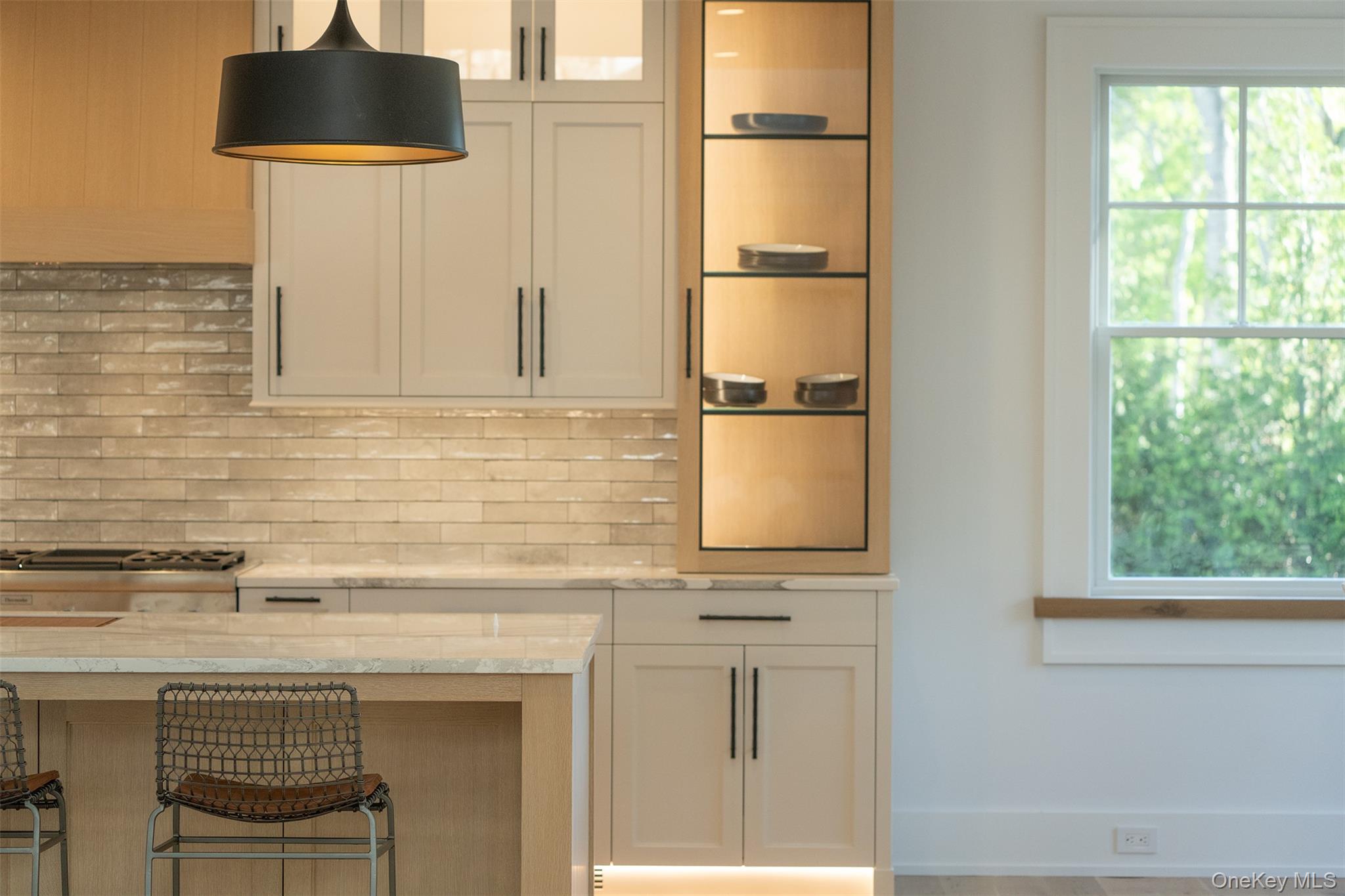 465 Ripple Water Lane Southold, NY 11971 - Photo 23 of 47 Bar area featuring light stone counters, glass insert cabinets, and white cabinets