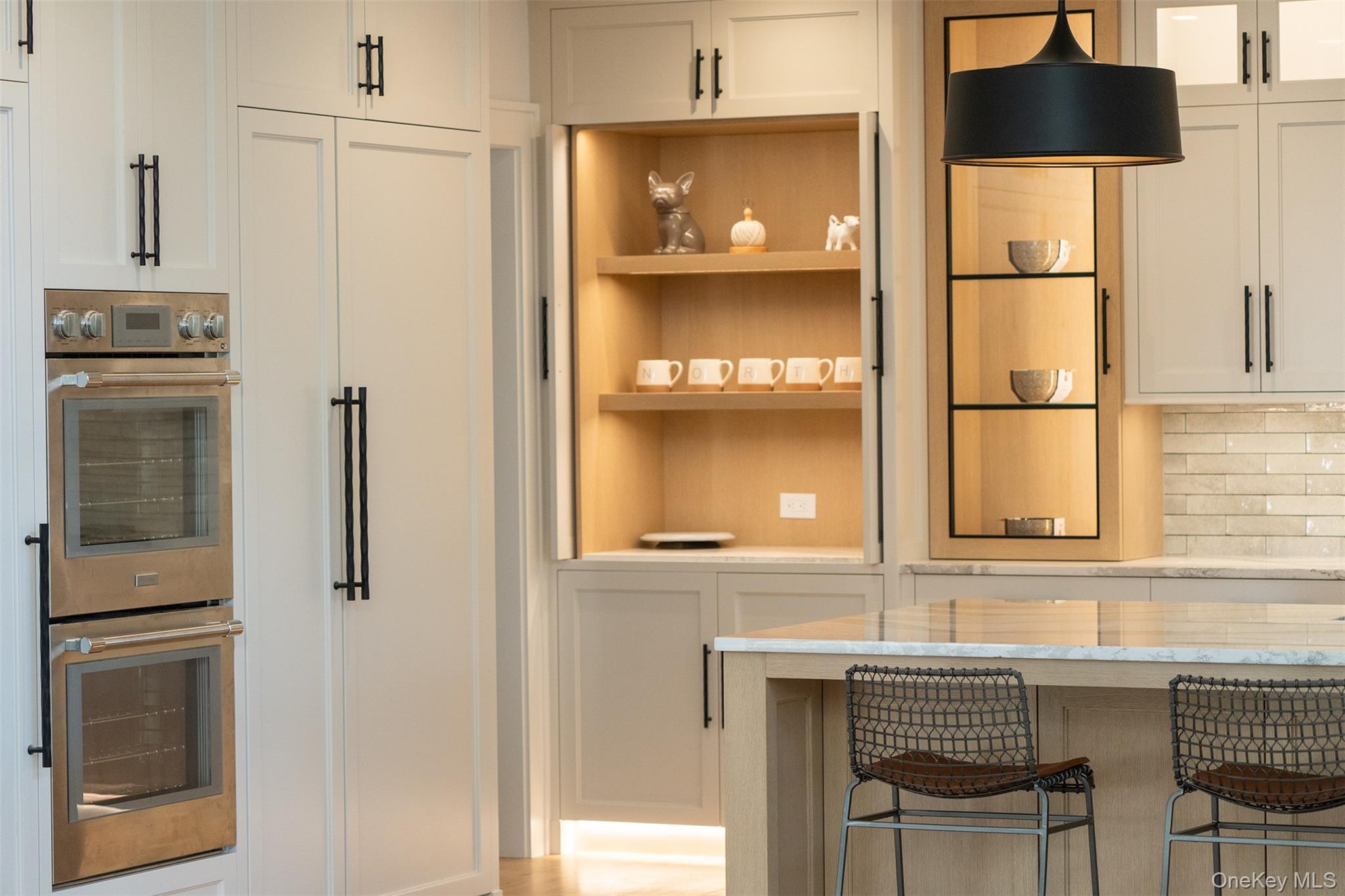 465 Ripple Water Lane Southold, NY 11971 - Photo 24 of 47 Kitchen with stainless steel double oven, white cabinetry, decorative backsplash, open shelves, and light stone counters