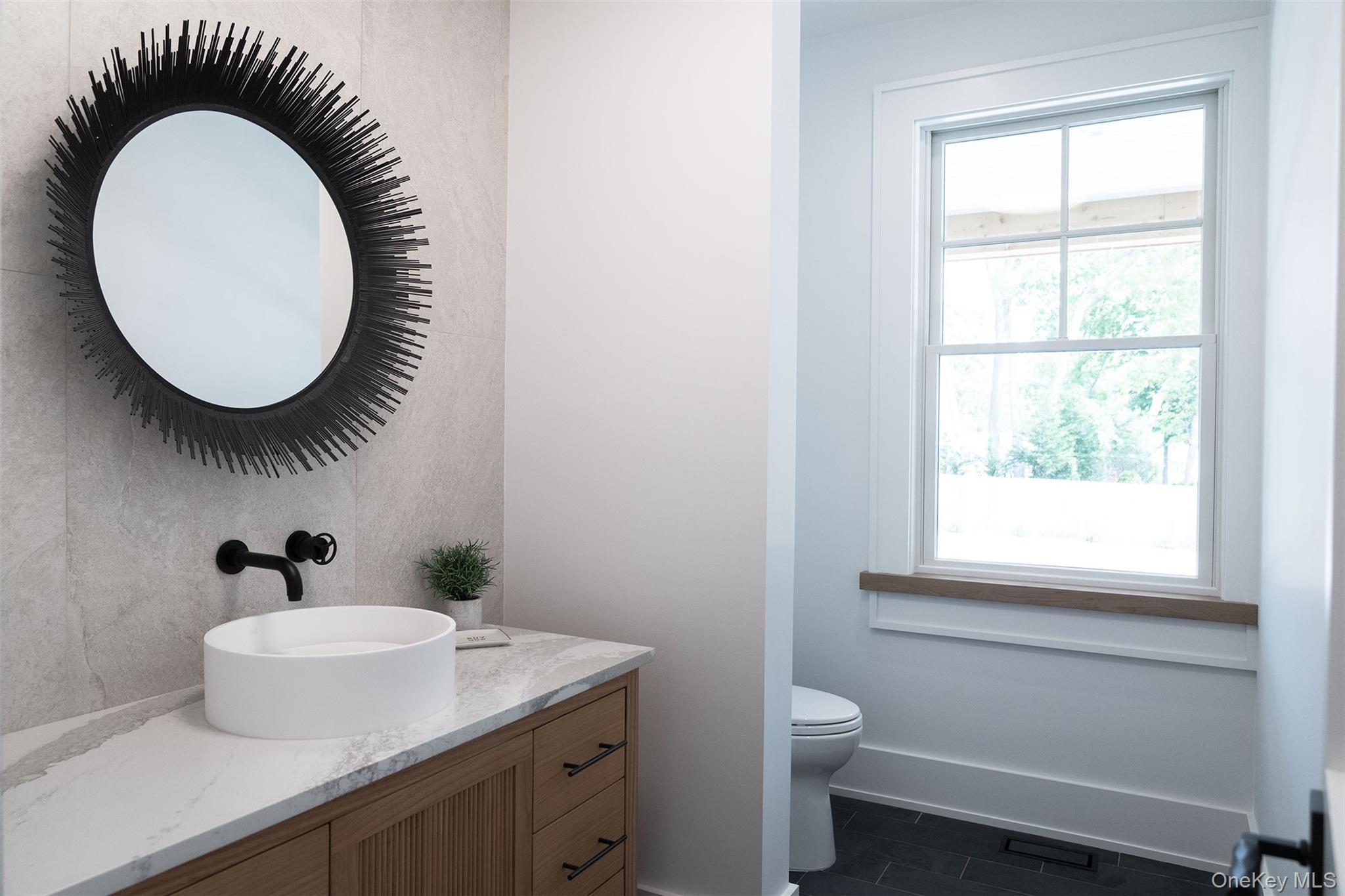 465 Ripple Water Lane Southold, NY 11971 - Photo 26 of 46 Bathroom featuring vanity and dark tile patterned flooring