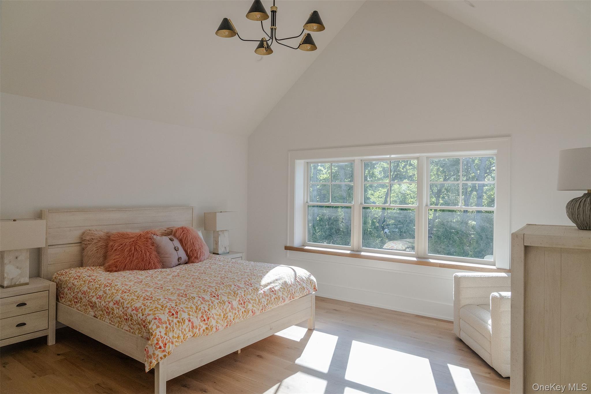 465 Ripple Water Lane Southold, NY 11971 - Photo 32 of 46 Bedroom with a chandelier, wood finished floors, and lofted ceiling