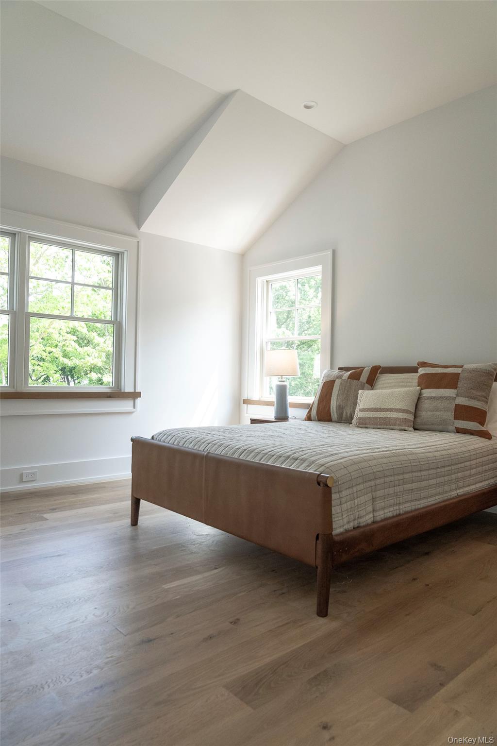 465 Ripple Water Lane Southold, NY 11971 - Photo 33 of 47 Bedroom featuring vaulted ceiling, wood finished floors, and multiple windows