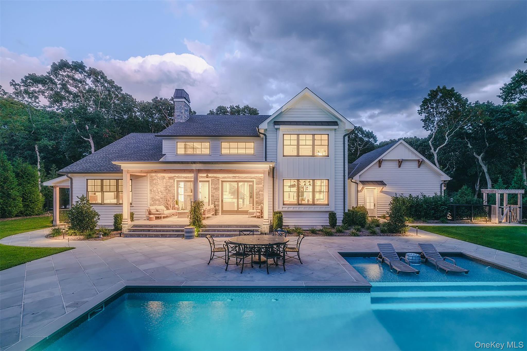 465 Ripple Water Lane Southold, NY 11971 - Photo 4 of 47 Back of house featuring an outdoor pool, a patio, a chimney, roof with shingles, and a yard
