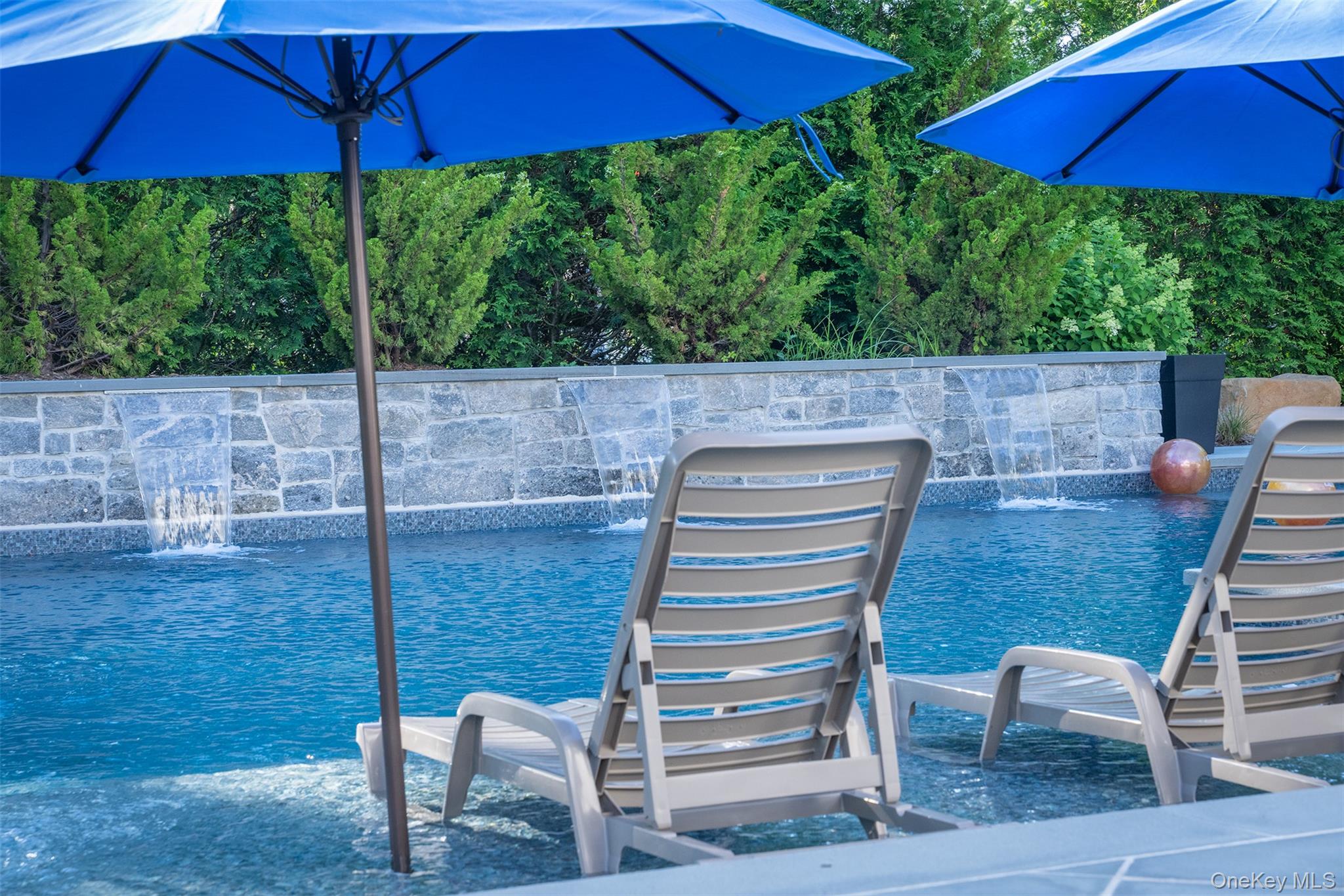 465 Ripple Water Lane Southold, NY 11971 - Photo 6 of 47 Outdoor pool with in pool lounge chairs