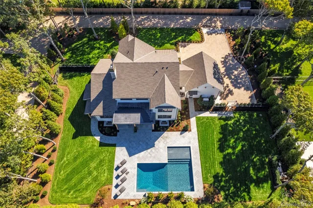 an aerial view of a house with a yard