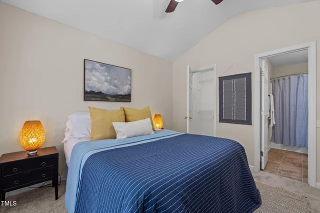 a bedroom with a bed and a lamp