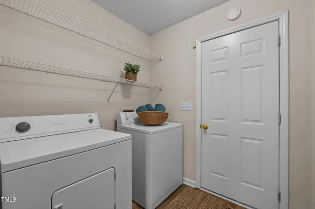 a view of storage and utility room with washer and dryer