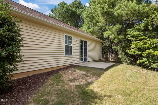 a view of a backyard with a large tree