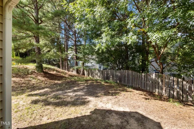 a view of wooden fence next to a yard