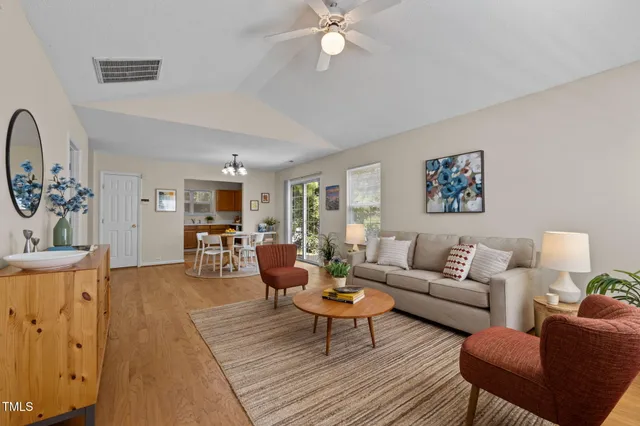 a living room with furniture and wooden floor