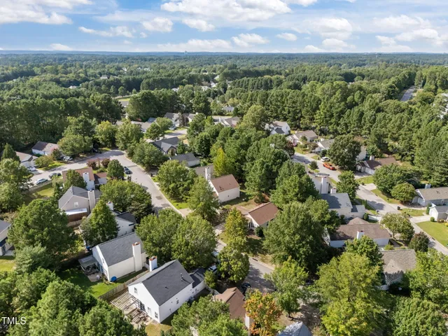 an aerial view of residential building with green space