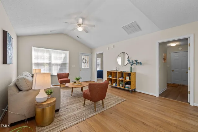 a living room with furniture and wooden floor