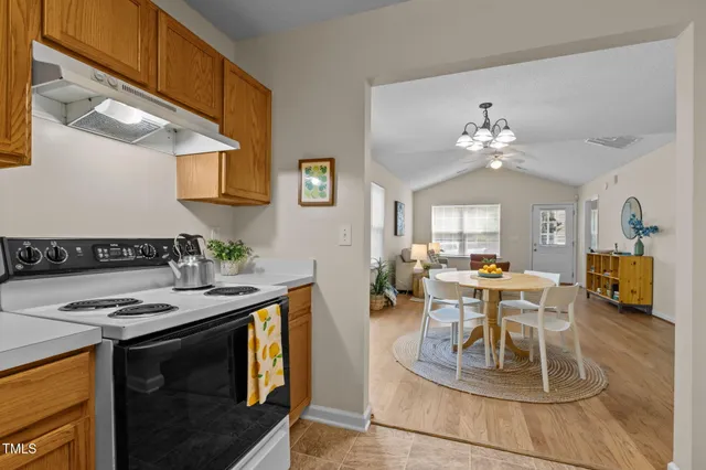 a view of a dining room and hall with a dining table chairs